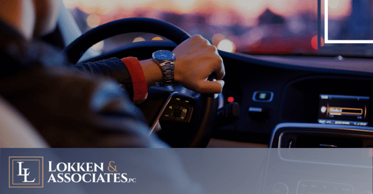 man driving car at dusk