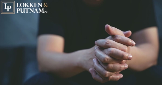 man's hands clasped together